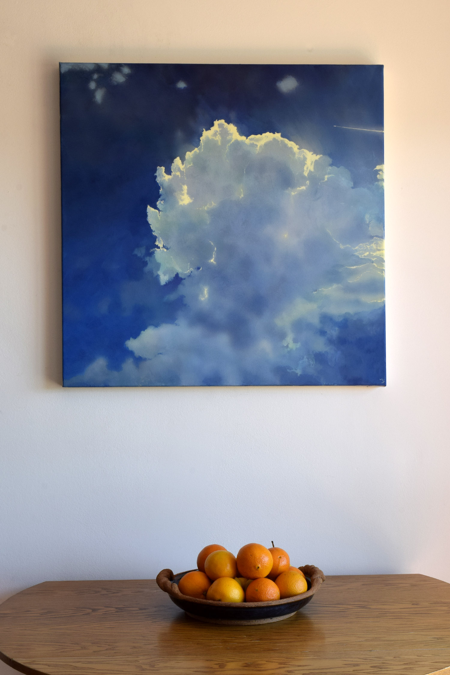 Icarus IV by John O'Grady | A skyscape displayed on a wall above a bowl of fruits